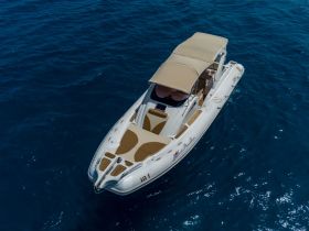 A stunning aerial view of a sleek speedboat cruising through deep blue waters, perfect for thrilling adventures on the sea.