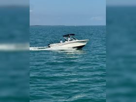 A speedboat navigates through turquoise waters, showcasing an exciting day on the water with guests enjoying the ride.