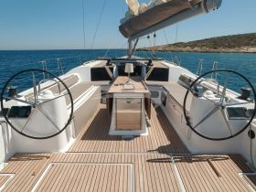 A beautifully designed helm area of a yacht, showcasing spacious seating and modern controls, perfect for navigating the open waters.