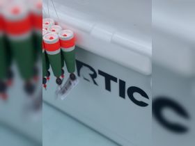 Close-up of colorful fishing gear hanging on a cooler, showcasing essential amenities for a day out on the water.
