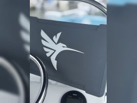Close-up of a boat's helm and console featuring a sleek design, ideal for navigating the open waters with style and precision.