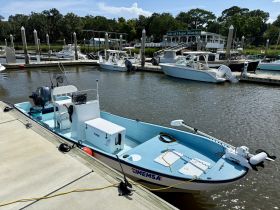A well-equipped fishing boat docked at Isle of Hope Marina, showcasing its spacious layout and amenities for a perfect day on the water.