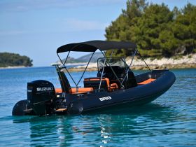 A sleek Brig speedboat glides through clear waters, showcasing its modern design and powerful Suzuki engine — perfect for exploring coastal destinations.