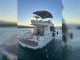A stunning view of a yacht docked at sunset, showcasing its elegant design and tranquil surroundings — perfect for luxury boating experiences.