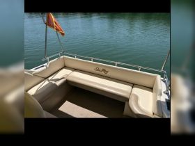 A cozy seating area inside a Sea Ray boat, perfect for relaxing while enjoying the water views.