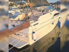 A beautiful Sea Ray boat docked in a serene marina, showcasing its sleek design and reflective waters.