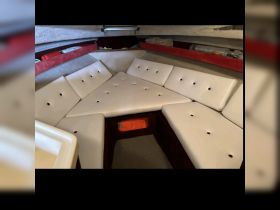 Interior view of a cozy boat cabin featuring comfortable seating, perfect for relaxing during trips on the water.