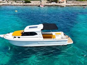A stunning view of a sleek boat named 'Ventos' cruising through crystal-clear turquoise waters, perfect for summer adventures on the sea.
