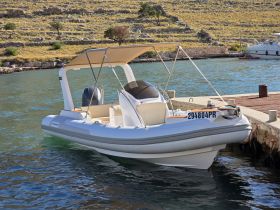 A sleek speedboat docked in calm waters, showcasing its modern design and inviting atmosphere for a day on the water.