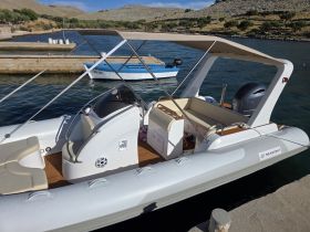 Interior view of a sleek inflatable boat showcasing comfortable seating and a modern helm, perfect for leisurely outings on the water.