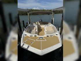 Interior view of a well-equipped boat featuring comfortable seating and a helm, perfect for a day on the water.