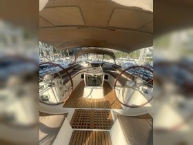 A well-appointed helm area inside a yacht, featuring comfortable seating and modern navigation equipment, perfect for a smooth sailing experience.