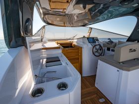 A sleek interior view of a boat's helm and seating area, showcasing modern design and functionality, perfect for comfortable cruising.