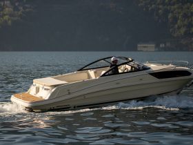 A sleek speedboat glides through calm waters, showcasing its elegant design and performance — perfect for thrilling day trips on the lake.
