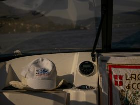 A cozy view of the boat's helm area featuring a stylish cap and decorative towel, perfect for a relaxing day on the water.