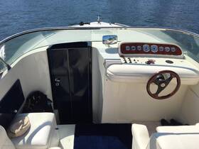 Interior view of a boat's helm and seating area, showcasing the control console and comfortable seating — perfect for navigating the waters.