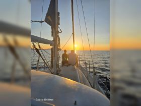 A couple enjoys a romantic sunset sailing experience, creating unforgettable memories on the water.