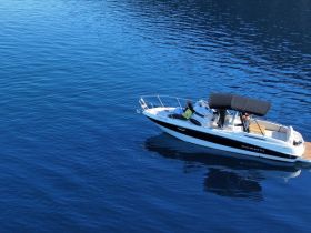 A sleek boat glides through calm blue waters, showcasing a perfect day for boating adventures.