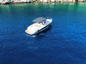 Aerial view of a sleek speedboat cruising through deep blue waters, perfect for exploring coastal destinations.