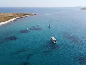 Boats resting in a clean turquoise bay