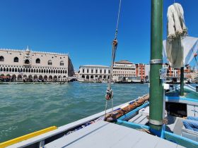 A scenic view from a boat in Venice, showcasing the stunning architecture along the canal — a perfect representation of the city's iconic waterways.