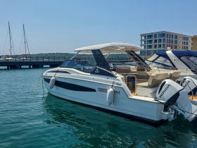 A sleek speedboat docked at a marina, showcasing its elegant design and pristine waters — perfect for day trips or leisurely cruises.