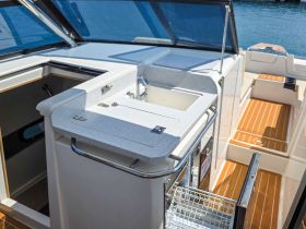 A well-designed helm area featuring a sleek console and sink, perfect for enjoying time on the water in comfort and style.