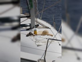A relaxing setup on a boat featuring a sun hat, sunglasses, and a refreshing drink, perfect for enjoying a day on the water.