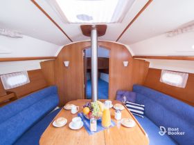 A cozy interior view of a boat's cabin featuring a dining area with breakfast items, perfect for enjoying meals while at sea.