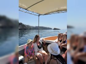 A family enjoys a relaxing moment aboard a boat, surrounded by scenic views — perfect for creating lasting memories on the water.