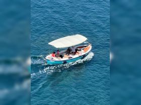 A lively group enjoys a day on the water aboard a colorful boat, showcasing the fun and excitement of on-water activities.