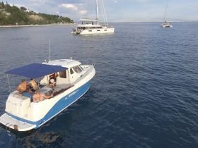A group of friends enjoys a relaxing day on a boat, soaking up the sun and the beautiful waters, perfect for a fun outing or celebration.