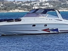 A sleek speedboat glides through clear waters, showcasing its stylish design and vibrant colors, perfect for thrilling adventures on the sea.