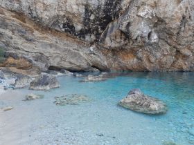 A scenic view of a rocky coastline with clear waters, but the image lacks clarity and detail.