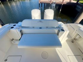 A clean and spacious interior view of a Cobia boat's helm and seating area, showcasing the modern design and comfort features ideal for a day on the water.