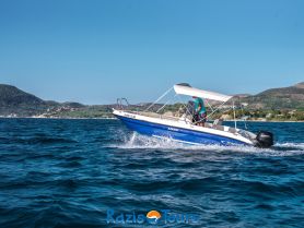 A speedboat named 'Poseidon' glides through the sparkling waters, showcasing a beautiful coastal backdrop — perfect for adventure seekers exploring the sea.