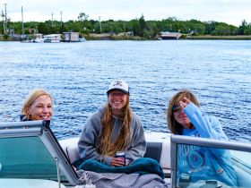 Three friends enjoy a relaxing moment on a boat, capturing the essence of a fun day on the water together.