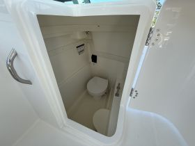 Inside view of a clean and modern boat bathroom, showcasing the essential amenities for comfort while at sea.