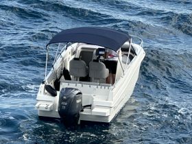 A sleek speedboat navigates through the waves, showcasing its modern design and powerful Yamaha engine — perfect for thrilling water adventures.
