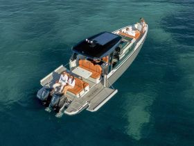 A couple enjoys a relaxing moment on a luxury boat, surrounded by clear ocean waters — perfect for a day of leisure on the water.