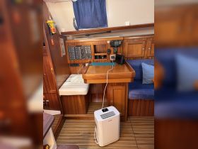Interior view of a boat's helm area featuring a well-equipped console and seating, ideal for navigation and comfort during voyages.