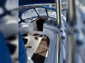 An inviting view of the interior helm area of a boat, featuring comfortable seating and a well-equipped space for navigation and relaxation.