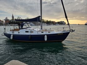 A beautiful sailboat docked in the harbor, showcasing its elegant design and serene surroundings — perfect for sailing enthusiasts and coastal adventures.
