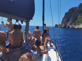 A lively group enjoys a sunny day sailing on the ocean, capturing the essence of friendship and adventure on the water.