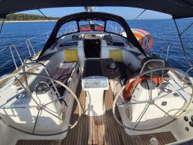 Inside view of a yacht's helm and seating area, showcasing a comfortable space for relaxation while cruising on the open water.