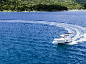 A sleek speedboat navigates through clear blue waters, showcasing its agility and design — perfect for thrilling water adventures.