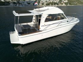 A stunning view of a Beneteau yacht anchored in calm waters, showcasing its elegant design and structure, perfect for leisurely cruises.