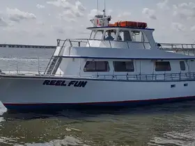The 'Reel Fun' boat is docked and ready for adventure, showcasing its spacious design and inviting atmosphere for fishing trips or leisure cruises.