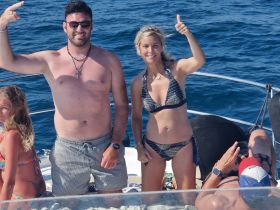 A cheerful group enjoys their time on a boat, celebrating with thumbs up and smiles — perfect for fun-filled days on the water.