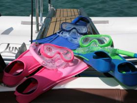 A vibrant collection of snorkeling gear, including flippers and masks, ready for underwater adventures — perfect for exploring marine life.